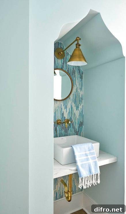 Moroccan sink nook with mosaic tile and brass mirror