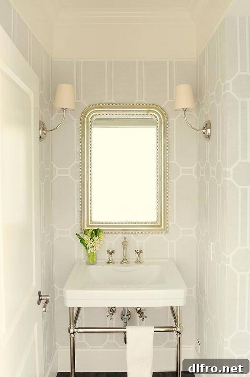 chic small powder room with patterned wallpaper and mirror