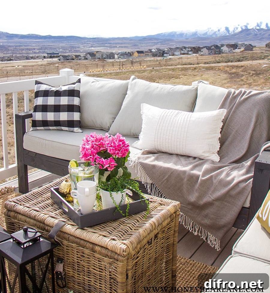 outdoor couch on porch with rattan chest coffee table throw pillows and throw blanket