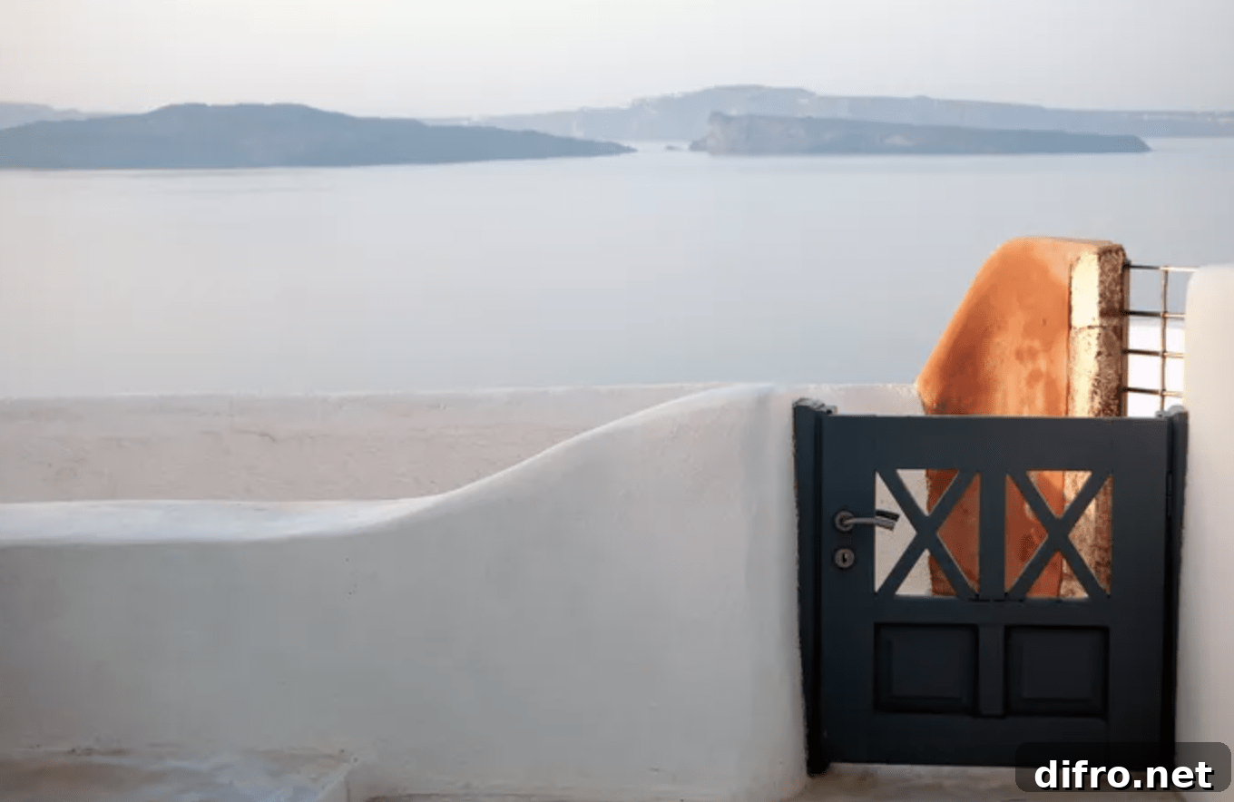 small wooden gate with stucco wall ocean in background