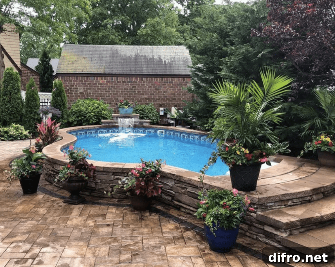 backyard above ground pool framed in with slate stone wall steps palms and planters