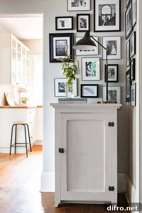 Foyer cabinet with black and white photo collage wall.