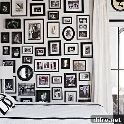 White bedroom with black and white photo wall gallery.