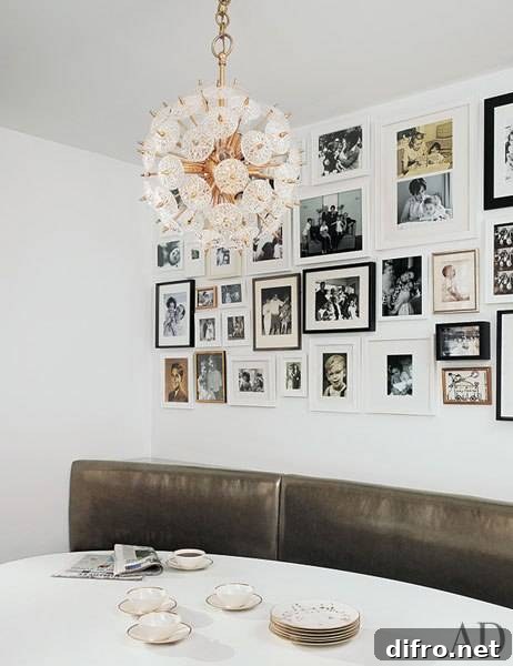Banquette dining space with eclectic photo wall gallery and brass chandelier.