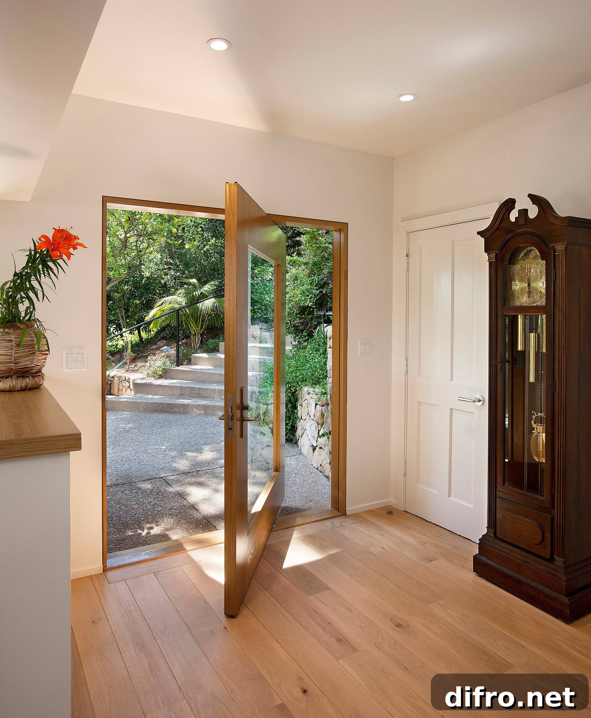 Glass pivot door opening to a lush backyard