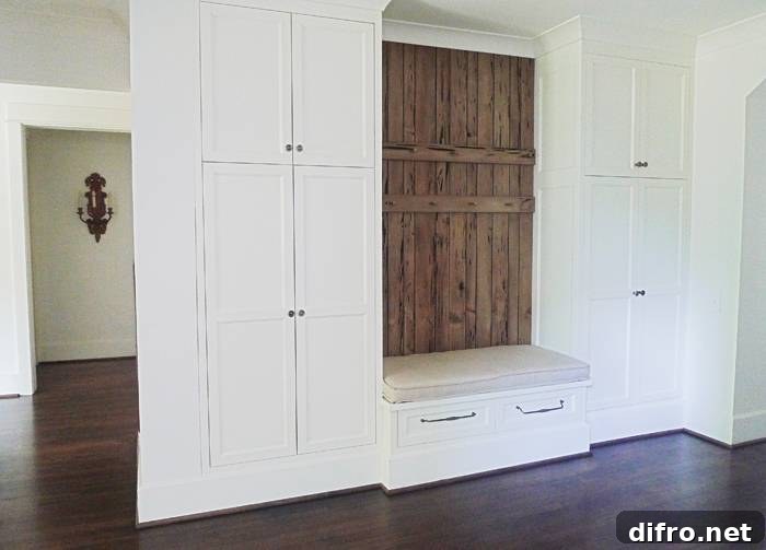 Mud room area with floor to ceiling shaker closets flanking a built-in storage bench
