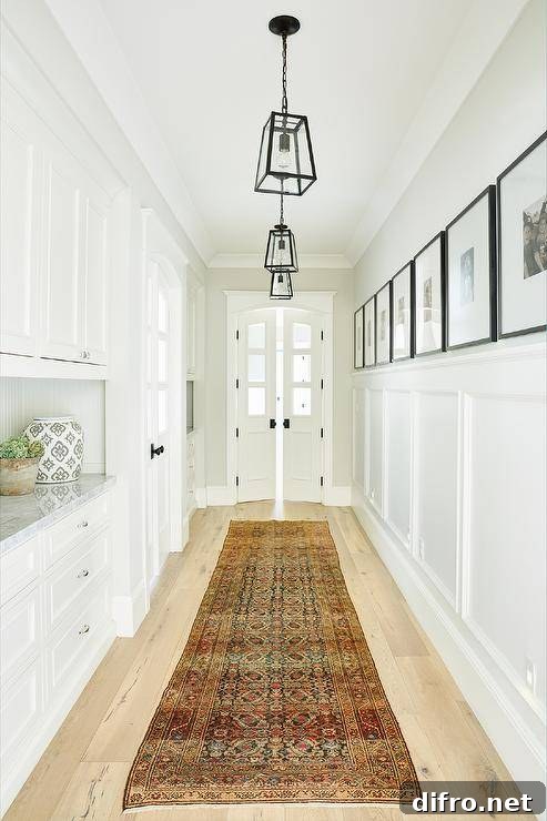 Seeded glass lanterns hang over a vintage runner leading to arched double doors