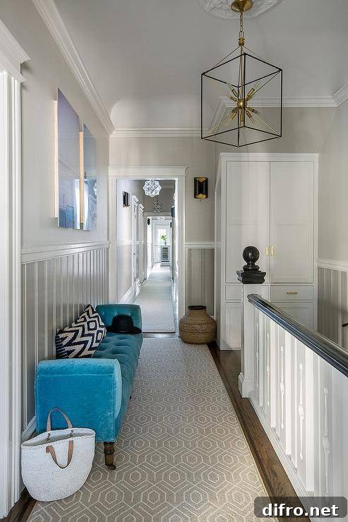 A second floor landing with a freestanding linen cabinet adorned with brass handles