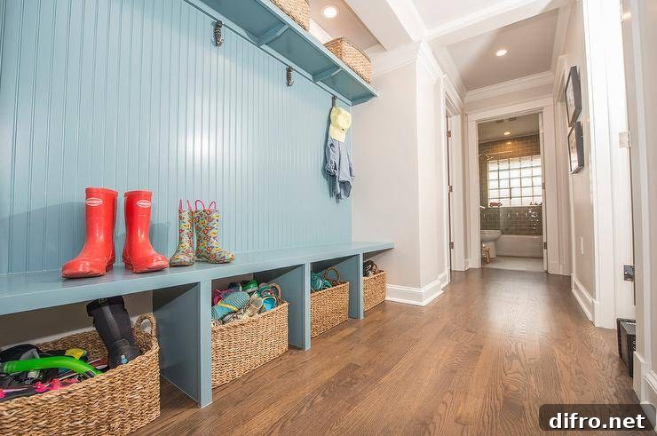 Long blue built-in mudroom bench with woven baskets for extra storage