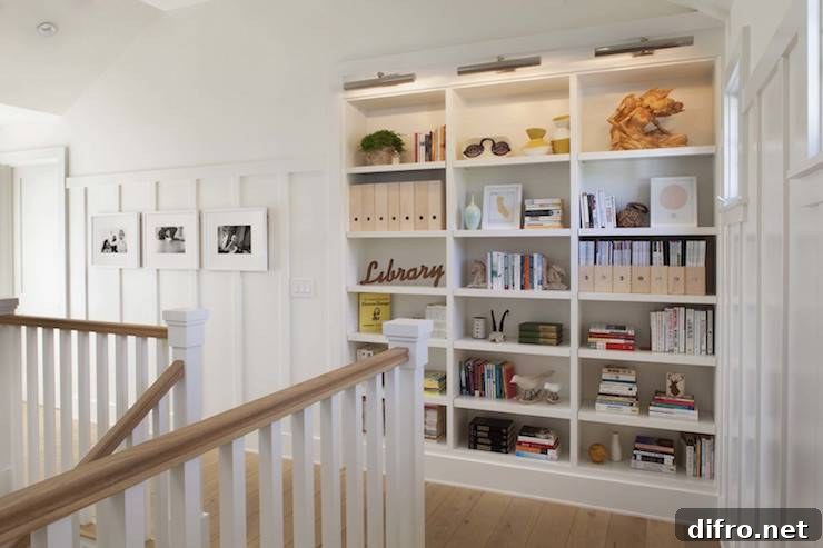 Second floor landing with built-in bookcase illuminated with picture lights
