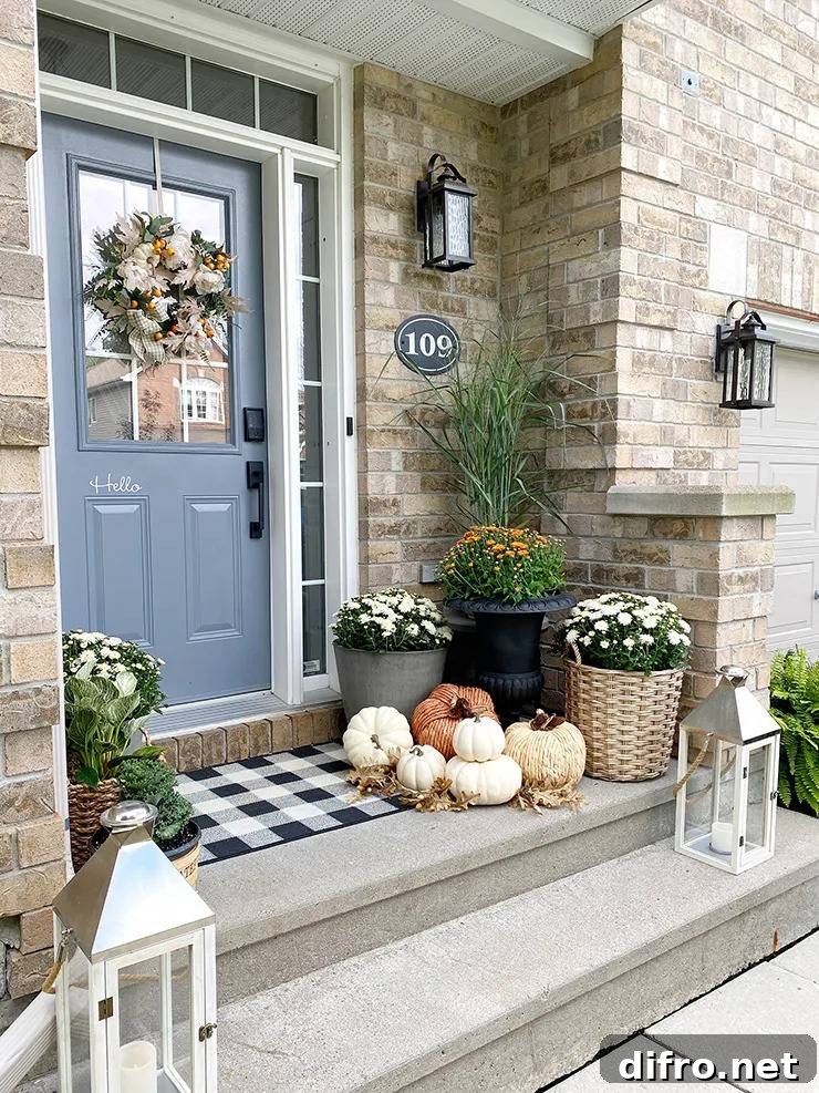Front porch decorated with pumpkins and lanterns