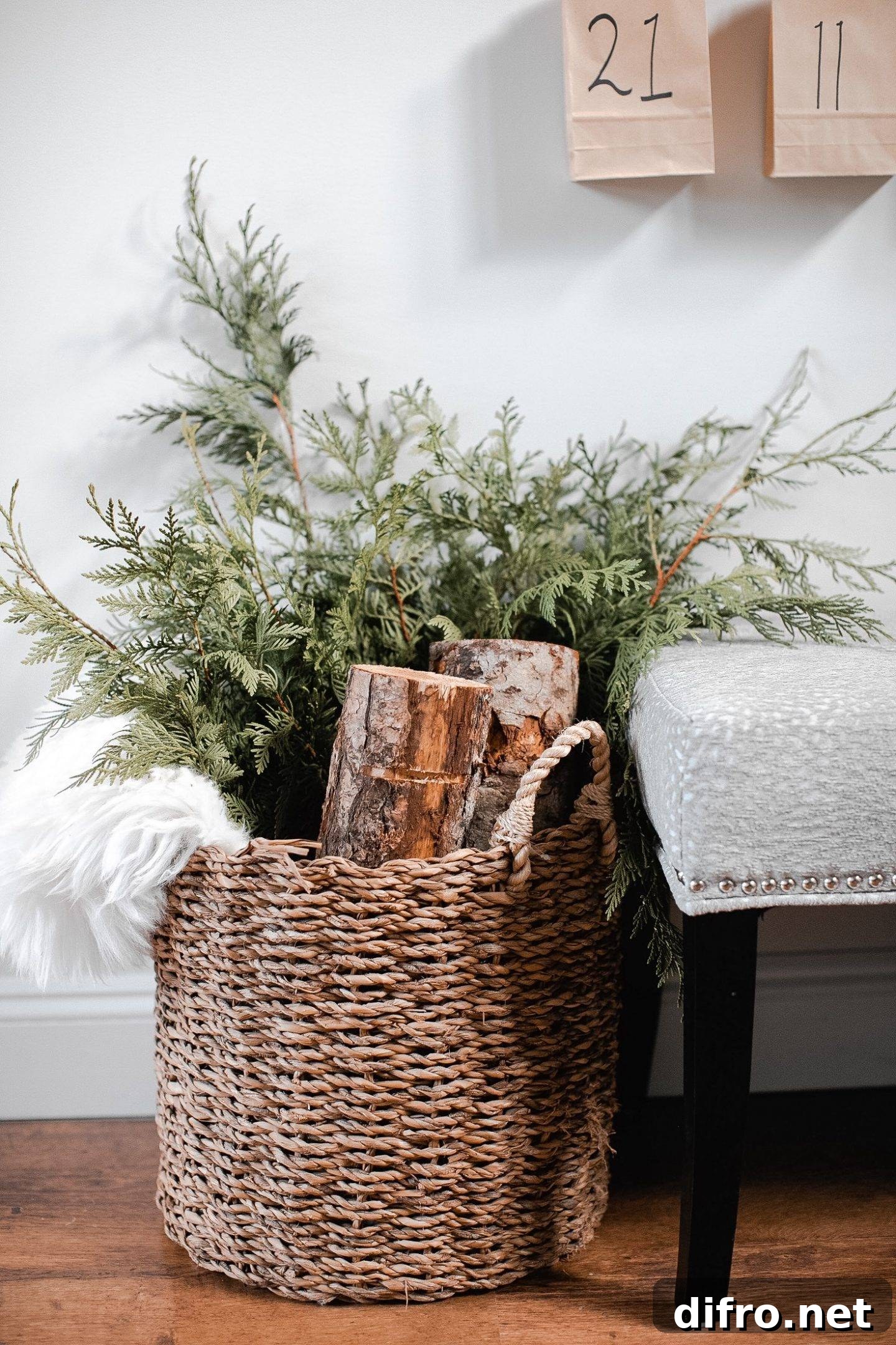 Winter greenery in a basket beside a fireplace