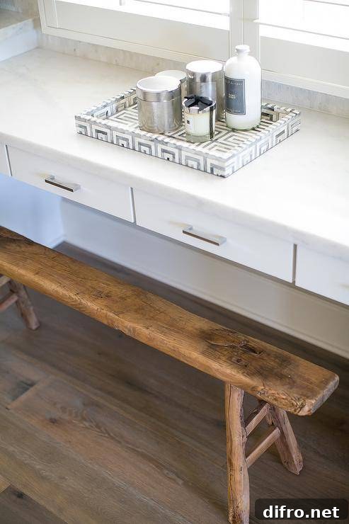 A marble Greek key tray on a white built-in makeup vanity.