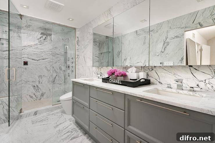 A black Chanel tray on a marble vanity.