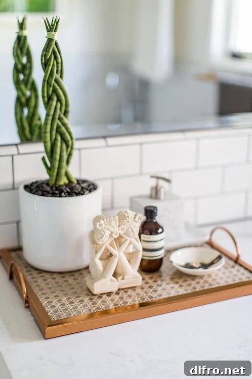Cane tray sits on a marble top vanity under a mirror in a bathroom.