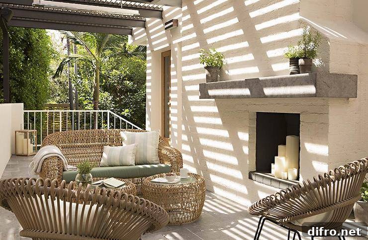 outdoor patio with a white brick fireplace and candles