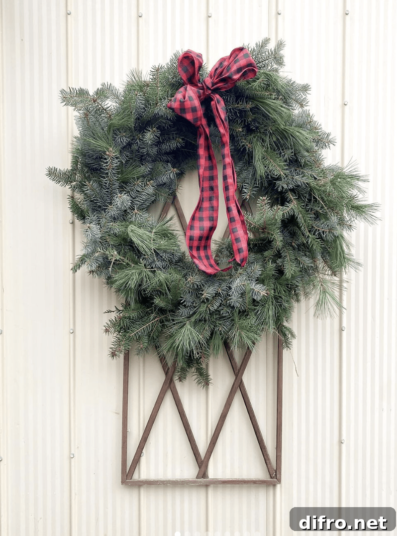 evergreen wreath with black and red plaid ribbon