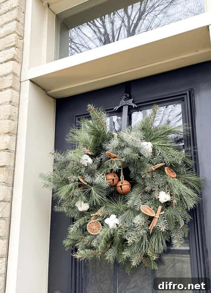 evergreen wreath with cinnamon dried oranges and cotton balls