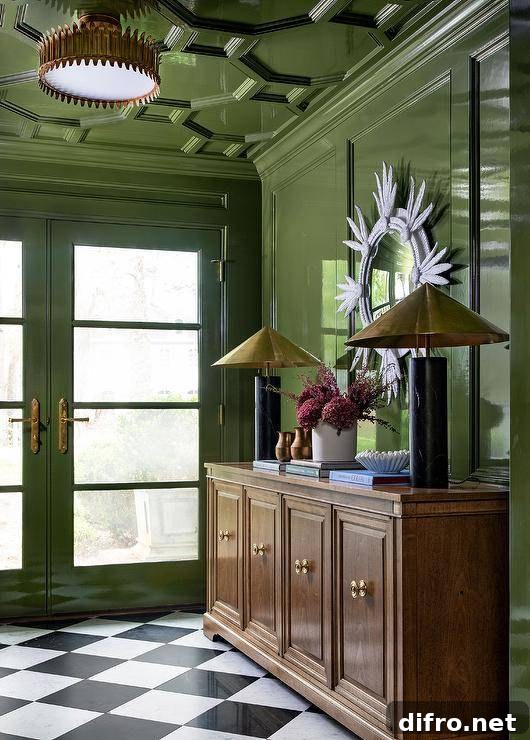 Contemporary foyer with glossy green lacquered wall and black-and-white flooring.