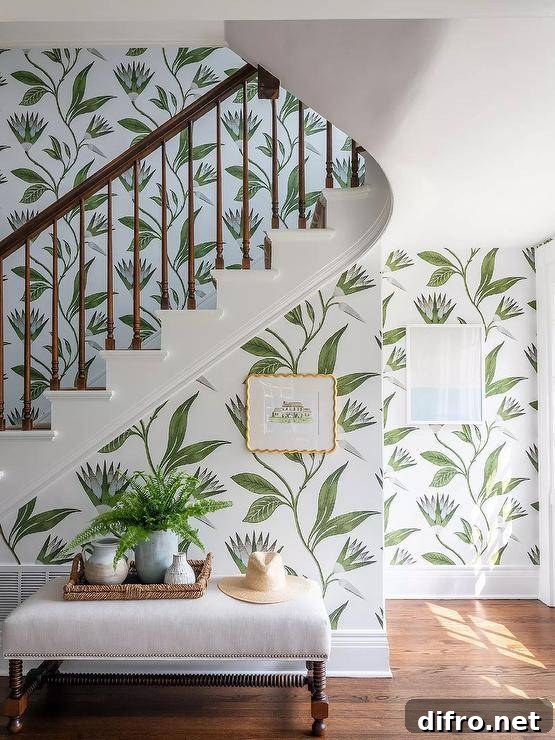 Patterned wallpaper covers a staircase wall behind an ivory bench.