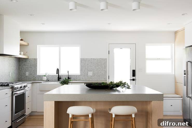 Minimal white and rift sawn oak cabinet kitchen with extra thick concrete countertops.