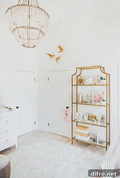 White nursery furnished with a gold etagere and elegant gold accents.
