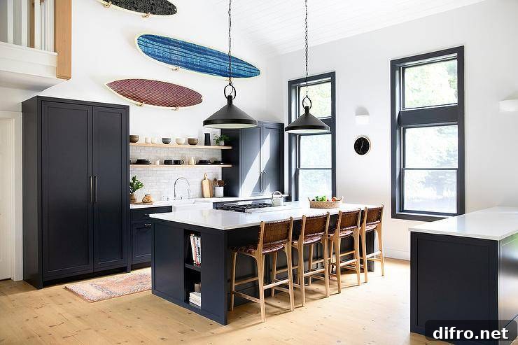 Decorative surfboards hang beneath a vaulted plank ceiling and over blond wood floating shelves mounted in front of light gray glazed backsplash tiles.