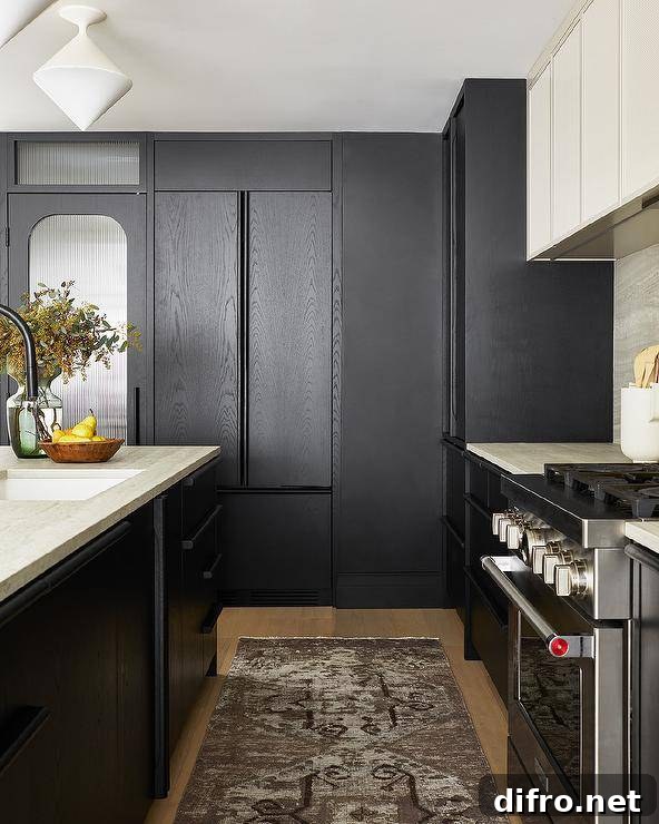 Modern black and ivory kitchen boasts a faded black runner placed between a black oak island topped with an ivory marble countertop lit by white diamond pendant lights and a stainless steel oven range.