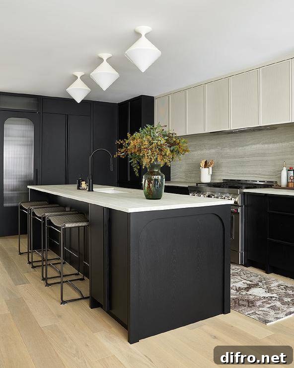 Two-toned ivory and black kitchen features white diamond pendant lights hung over a black oak center island topped with an ivory marble countertop.