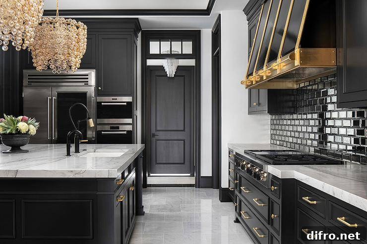 Well-appointed kitchen boasts a gold and black faucet accenting a sink fixed to a gray marble countertop accenting a black island adorned with brass hardware.
