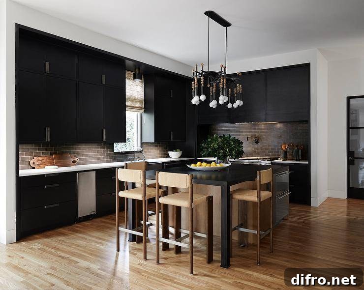 Beige stools complement a black and beige kitchen island fitted with stacked stainless steel dishwashers in a well-appointed modern black kitchen.