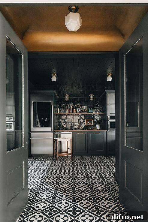 Modern kitchen features a black pantry with a glass door fridge, a wooden floating shelf on glossy black square backsplash tiles, black cabinets, a stainless steel dishwasher, black shiplap ceiling and black and white mosaic pantry floor tiles.