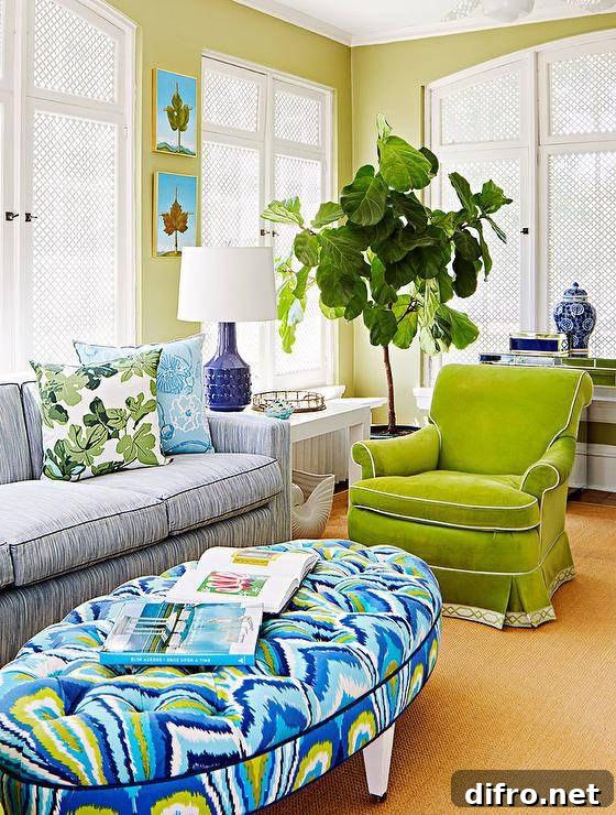 Contemporary green and blue living room features an oval green and blue tufted ottoman placed in front of a blue striped sofa accented with blue and green pillows.