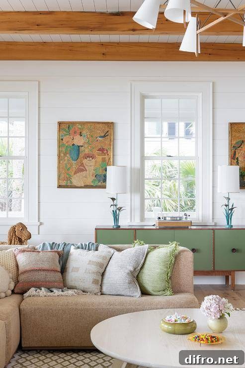 A tan sectional accented with tan and green pillows sits on a green and white diamond pattern rug.