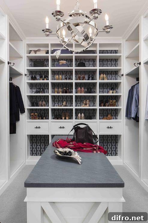White and gray closet with patterned wallpaper backing on shoe shelves.