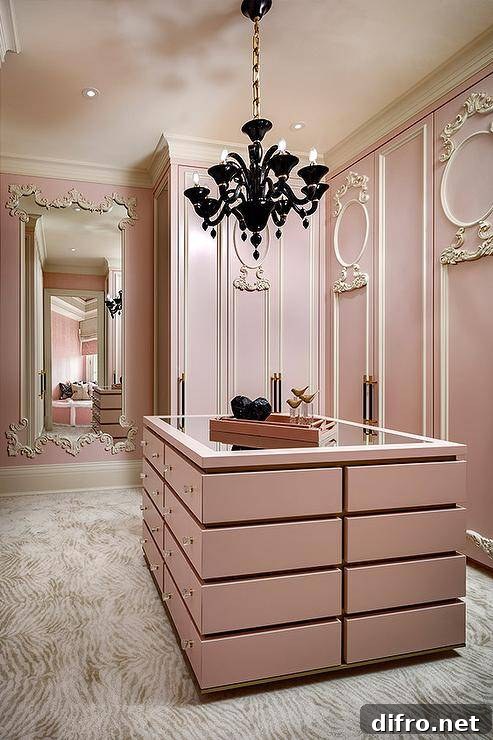French pink closet with pink island and decorative chandelier.