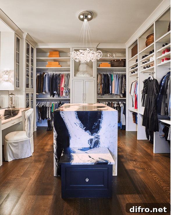 Closet island with black and white marble waterfall edge and built-in shelves.