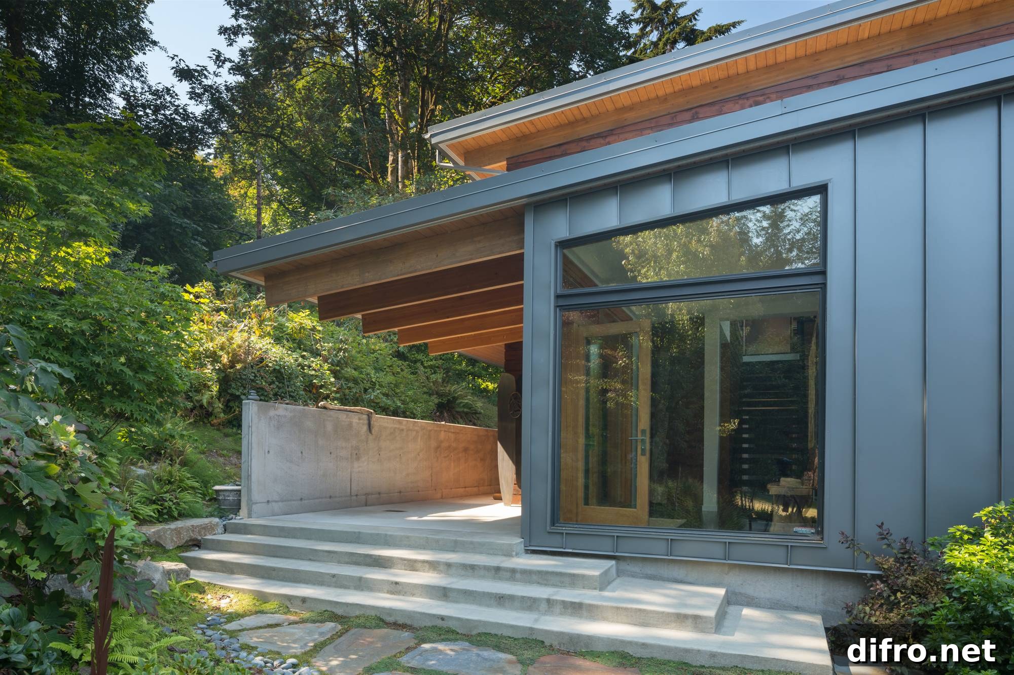 stone steps up to entryway of metal framed home