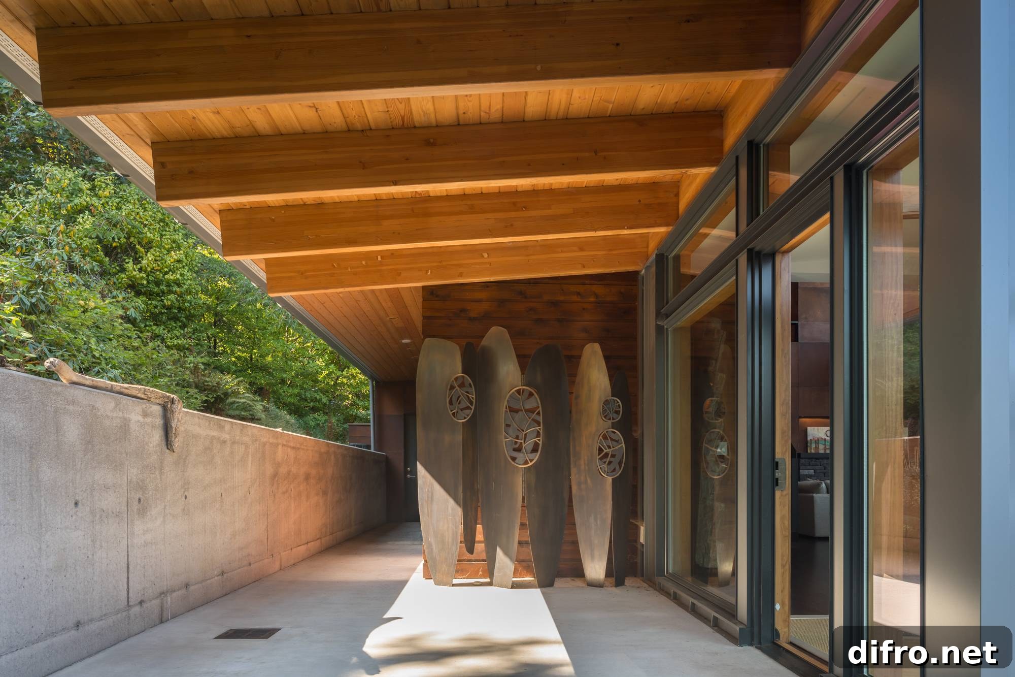 tall wooden sculptures leaning on wall of concrete entranceway