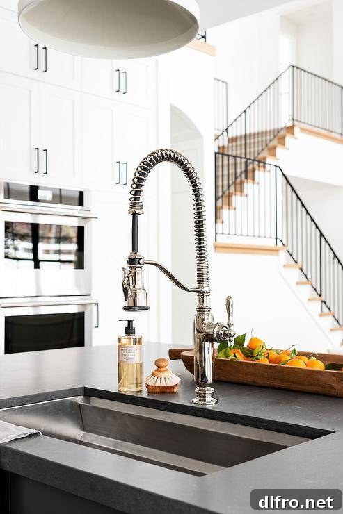 A black leathered granite kitchen countertop with stainless steel sink