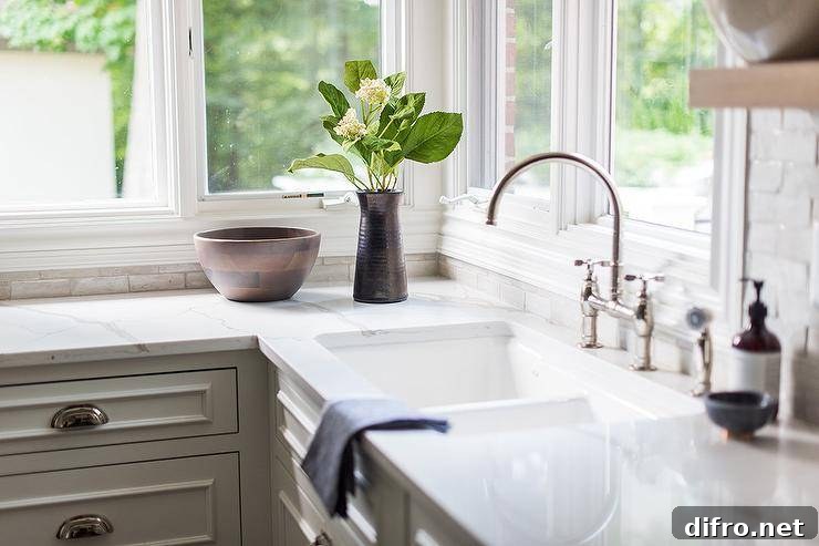 Beneath windows, a cast iron dual sink matched with a polished nickel deck mount faucet