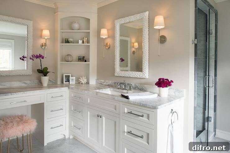 Built-in white makeup vanity with marble countertop and pink faux fur stool