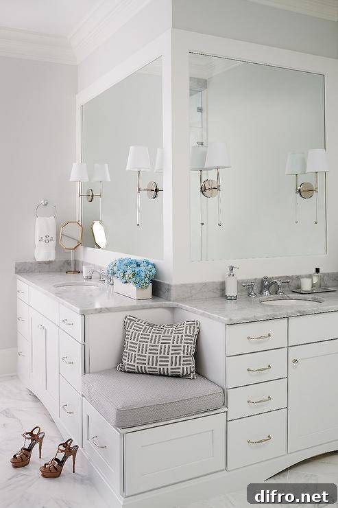 Built-in corner bench flanked by his and hers washstands topped with Carrera marble