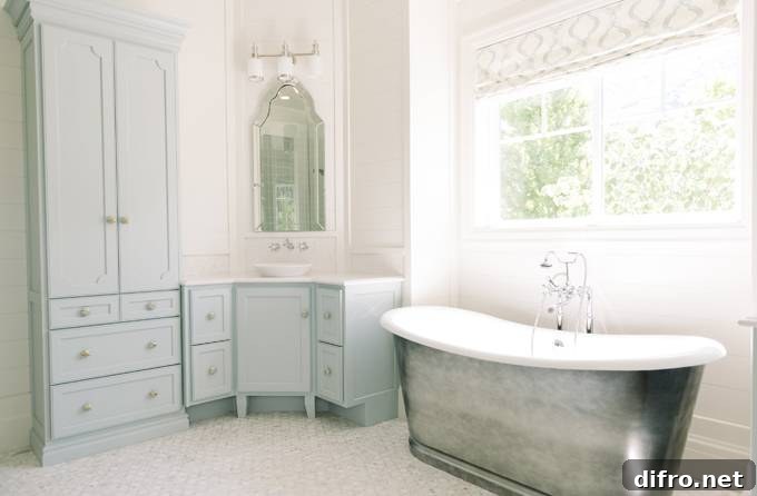 Blue corner washstand topped with white marble under an arch mirror