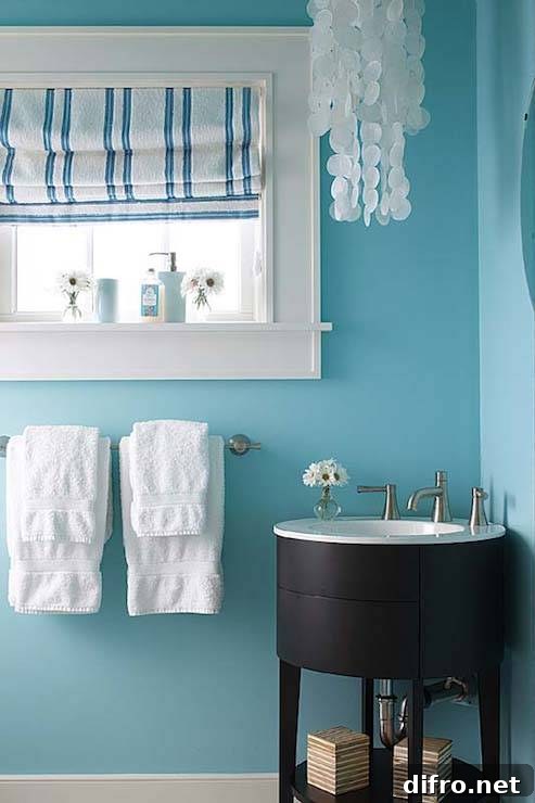 Round espresso corner vanity in a white and turquoise powder room
