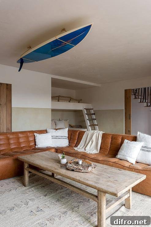 Brown leather tufted sectional with a reclaimed wood coffee table under a decorative ceiling feature.
