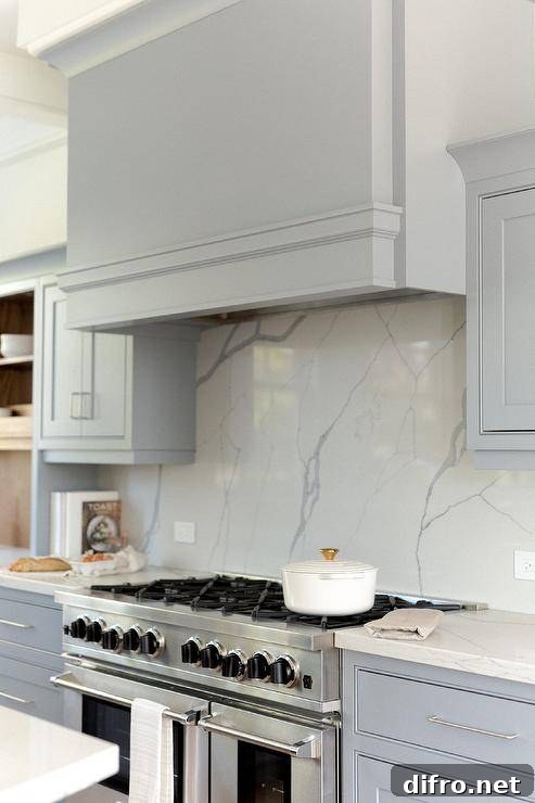 Light blue wooden mantle hood over a stainless steel range