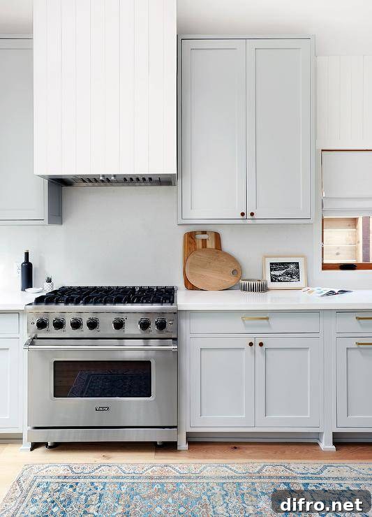 White plank range hood above a stainless steel Viking range