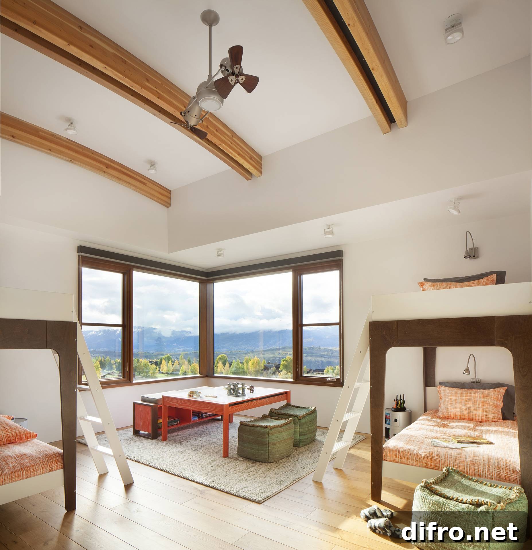 wooden beams on ceiling of large bedroom with bay windows and multiple sets of bunkbeds