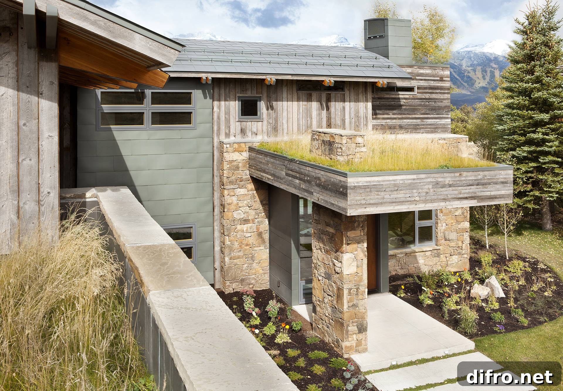 stone overhang and living roof over front entrance of home